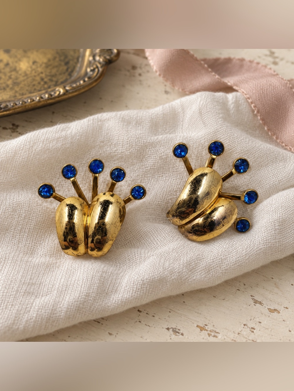 Gold-tone Clip Earrings with Blue Crystal Accents